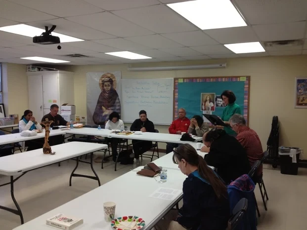 Fraternity members in discussion around tables